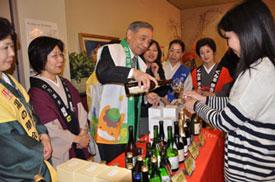 写真：地元の人に群馬の梅酒や地酒を振る舞う大澤知事