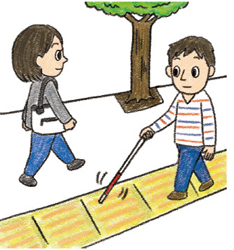 視覚障害のある人が、点字ブロックの上を歩いている画像